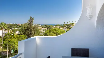 a room with a chair and a white wall at Sienna in Vale do Lobo