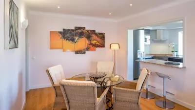 a dining room with a glass table and chairs at Sienna in Vale do Lobo