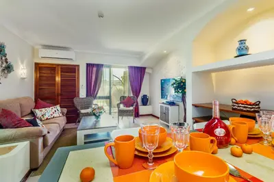 a living room with a table with glasses on it at Clementina Duplex apartment in Albufeira