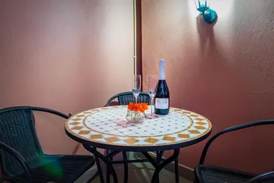 a table with a bottle of wine and two glasses at Clementina Duplex apartment in Albufeira