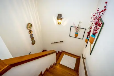 a staircase in a home with white walls and wooden floors at Clementina Duplex apartment in Albufeira