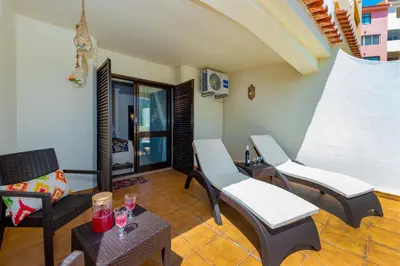 a living room with chairs and a table at Clementina Duplex apartment in Albufeira