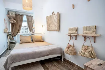 a bedroom with a bed and baskets on the wall at Baixa de Faro Rooftop in Faro
