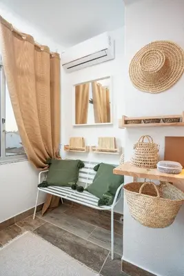 a room with a bench and a mirror and a window at Baixa de Faro Rooftop in Faro