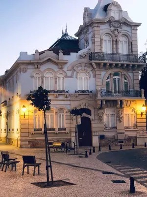 a building with a tree in front of it at Baixa de Faro Rooftop in Faro