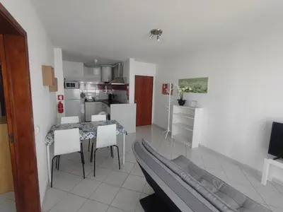 a kitchen and living room with a table and chairs at Alsol C 5365-1 in Quarteira