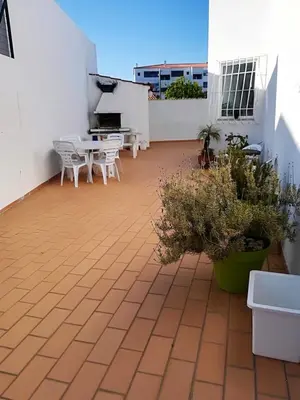 a patio with tables and chairs on a building at Luxurious villa in Albufeira with pool in Albufeira