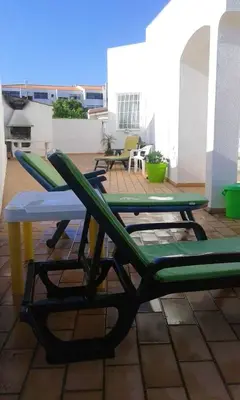 a patio with a table and chairs on a roof at Luxurious villa in Albufeira with pool in Albufeira