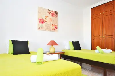 a room with two beds with yellow sheets at Villa Waikiki by Algarve Vacation in Albufeira