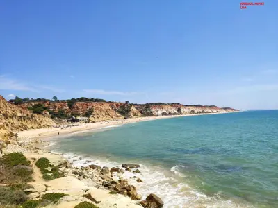 a view of a beach with rocks and the ocean at Alsol C 5360 in Quarteira