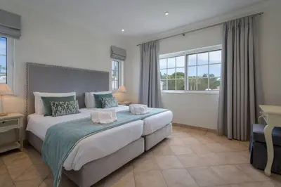 a bedroom with a large bed and a window at Aleisha in Vale do Lobo