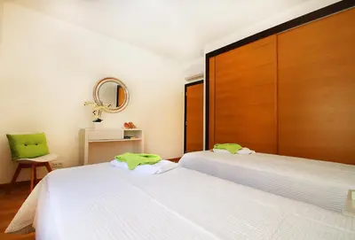 a bedroom with two beds and a mirror at Apartment Caracas 1 by Algarve Vacation in Albufeira