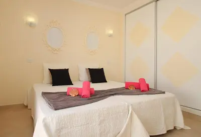 a bedroom with two beds with pink pillows on them at Villa Moorea by Algarve Vacation in Guia