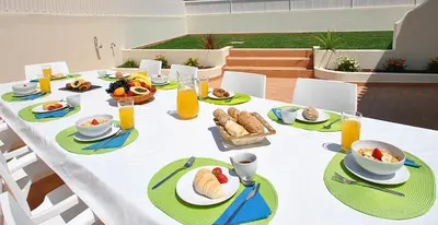 a white table with food and drinks on it at Villa Moorea by Algarve Vacation in Guia