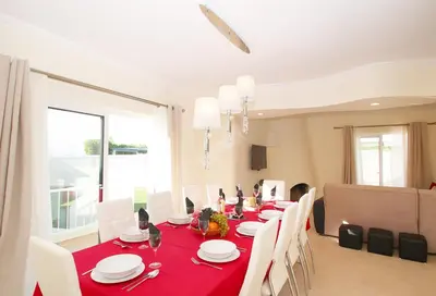 a dining room with a red table and chairs at Villa Moorea by Algarve Vacation in Guia