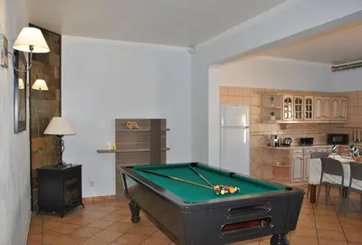 a room with a pool table in a kitchen at Villa Zanzibar by Algarve Vacation in Olhos de Água