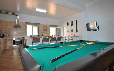 a kitchen with a pool table in a living room at Villa Zanzibar by Algarve Vacation in Olhos de Água