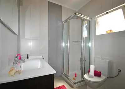 a bathroom with a shower and a sink and a toilet at Villa Zanzibar by Algarve Vacation in Olhos de Água