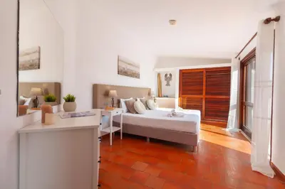 a bedroom with a bed and a desk in it at Villa Kailua by Algarve Vacation in Albufeira