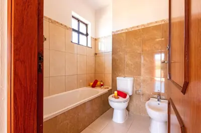 a bathroom with a toilet and a tub and a sink at Villa Morais by Algarve Vacation in Guia