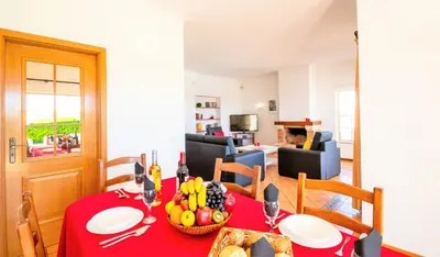 a dining room with a red table with fruit on it at Villa Boracay by Algarve Vacation in Albufeira