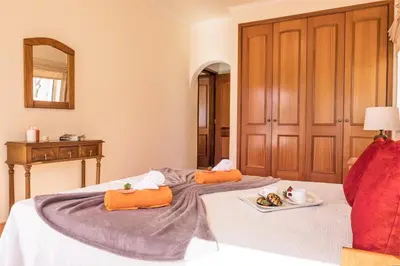 a bedroom with two beds with orange pillows at Villa Melanésia by Algarve Vacation in Guia