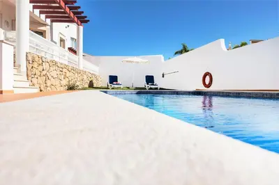 a swimming pool in a villa with white walls at Villa Melanésia by Algarve Vacation in Guia