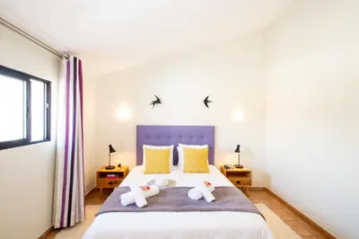 a bedroom with a bed with two stuffed animals on it at Villa Krabi by Algarve Vacation in Albufeira