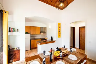 a kitchen and dining room with a table and chairs at Villa Krabi by Algarve Vacation in Albufeira