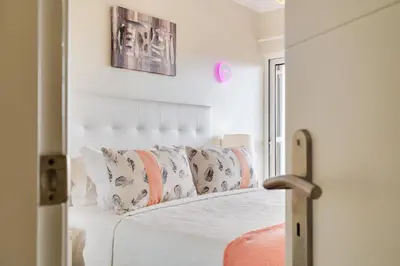 a balcony with chairs and a swimming pool at Palmeira Galé Apartment in Albufeira