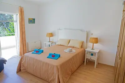 a bedroom with a bed with two blue boxes on it at Villa Tulum by Algarve Vacation in Almancil