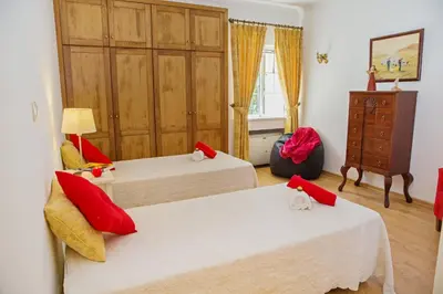a room with two beds and a dresser in it at Villa Tulum by Algarve Vacation in Almancil