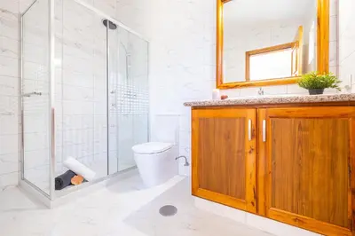 a bathroom with a toilet and a glass shower at Villa Crisandra by Algarve Vacation in Albufeira
