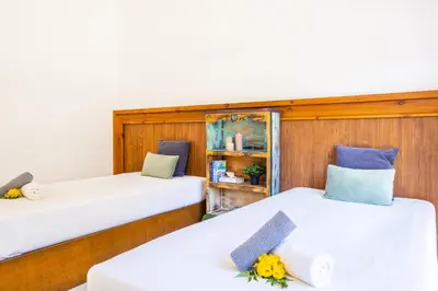 two twin beds in a room with wood paneling at Villa Crisandra by Algarve Vacation in Albufeira