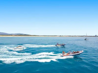 a group of people in boats in the water at Villa Turtle Beach by Algarve Vacation in Albufeira
