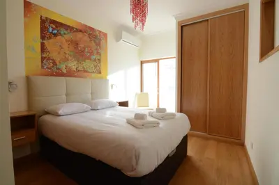a bedroom with a bed with two towels on it at Eugenia's House in Faro