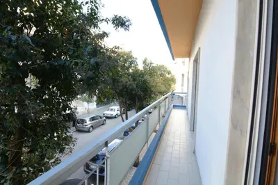 a balcony of a building with cars parked on a street at Eugenia's House in Faro
