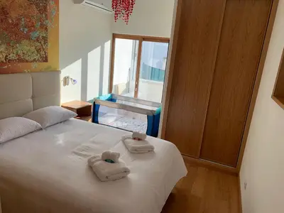 a bedroom with a bed with towels on it at Eugenia's House in Faro