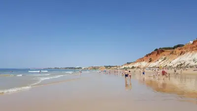 a group of people standing on a beach at Alsouk in Vilamoura
