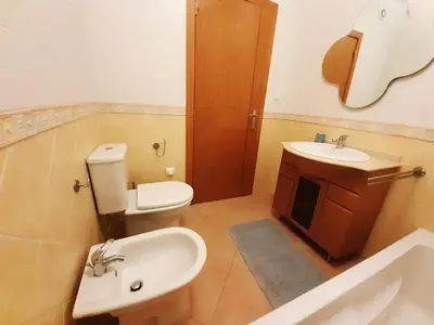 a bathroom with a toilet and a sink at Apartamento Alfarrobeira Mar in Quarteira