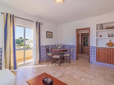 a living room with a table and a balcony at Villa Flor de Maio by Interhome in Patroves
