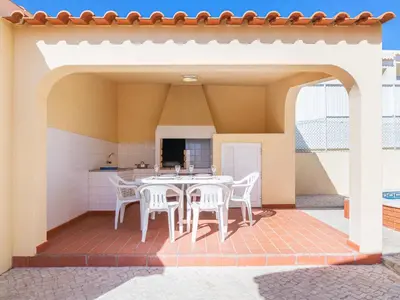 a patio with a table and chairs under a roof at Villa Flor de Maio by Interhome in Patroves