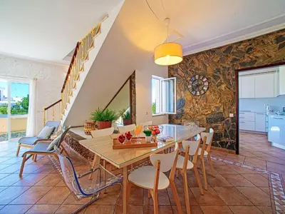 a kitchen with white cabinets and a large window at Holiday Home Casa do Sol by Interhome in Patroves