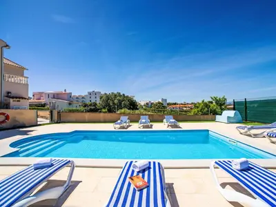 a bedroom with two beds with blue and white pillows at Holiday Home Casa do Sol by Interhome in Patroves