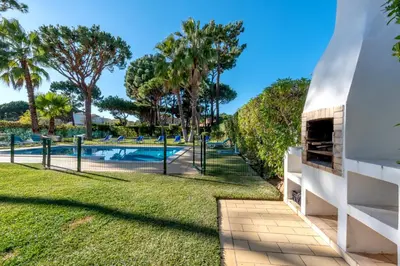 a view of the pool and the backyard of a house at Villa with Garden and Pool in Vilamoura