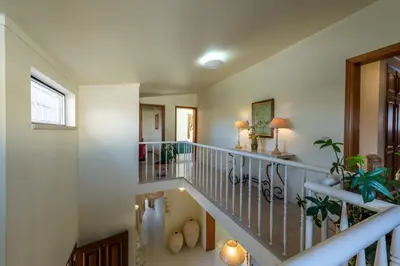 a staircase in a home with white walls at Villa with Garden and Pool in Vilamoura