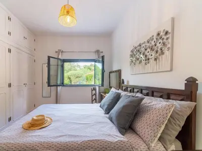 a bedroom with a bed with a hat on it at Casa O Sonho near Faro with private pool in Santa Bárbara de Nexe