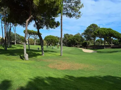 a view of a golf course with trees and a green at Sunny Balcony Apartment and Pool in Vilamoura