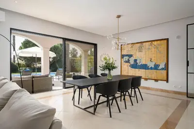 a dining room with a table and chairs at Villa Coral - Varandas do Lago in Almancil