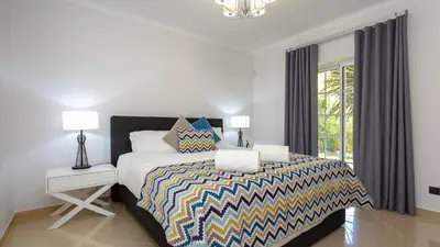 a bedroom with a large bed and a window at Villa Natura - Varandas do Lago in Almancil